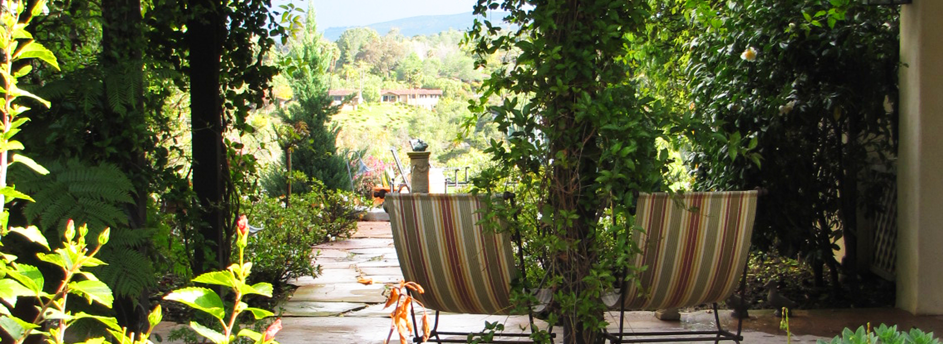 Two Chairs Under a Garden Trellis Looking Out Over California Hills